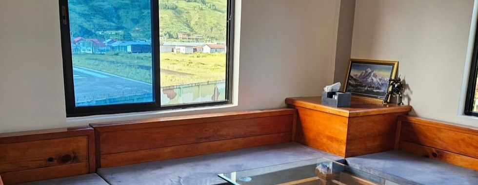 Warm fireplace and common seating area at Khusimsim Mechuka homestay for guest evenings