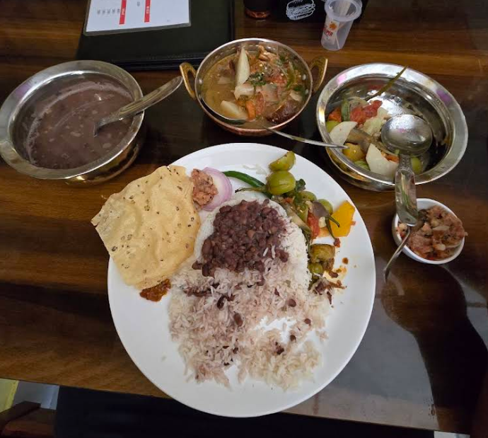 Spacious Koko Restaurant dining hall at Tothro Resort Anini, wooden tables set for Arunachali meals