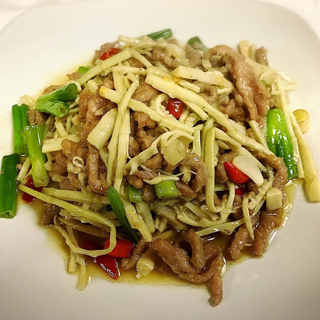 Nagaland pork with bamboo shoots traditional dish in earthen pot with green vegetables