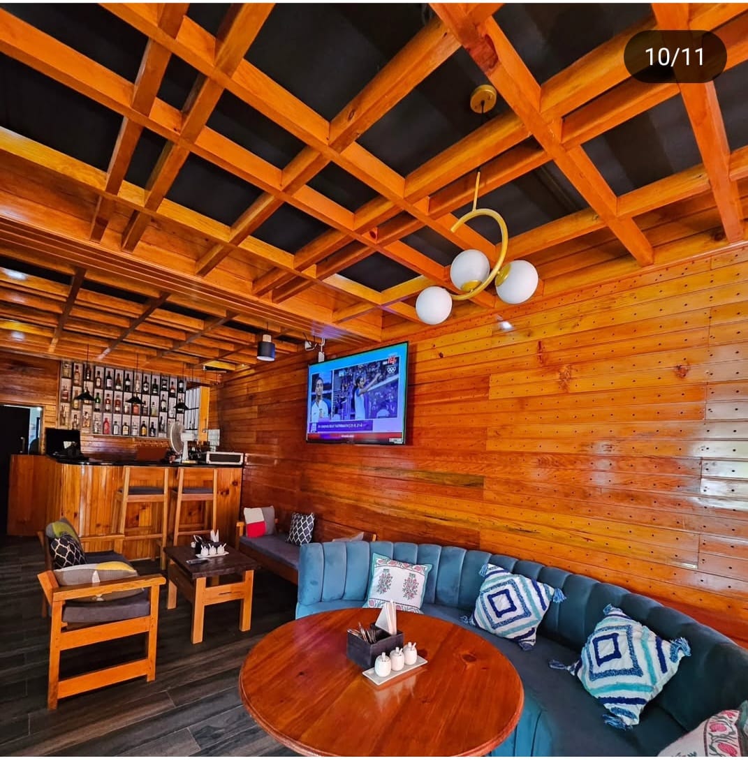 Warm fireplace and common seating area at Khusimsim Mechuka homestay for guest evenings