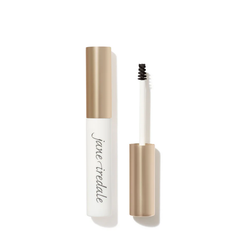 A white make up contianer with a light bronze top contaning an eye brow applicator.