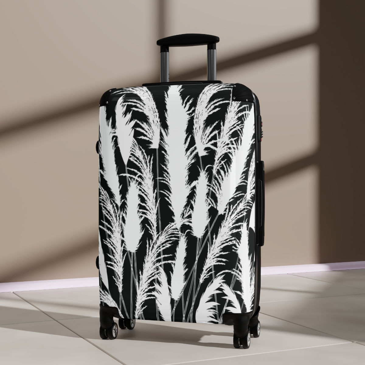Black and white hard shell suitcase with printed white pampas grass silhouettes on a moonlit black background.