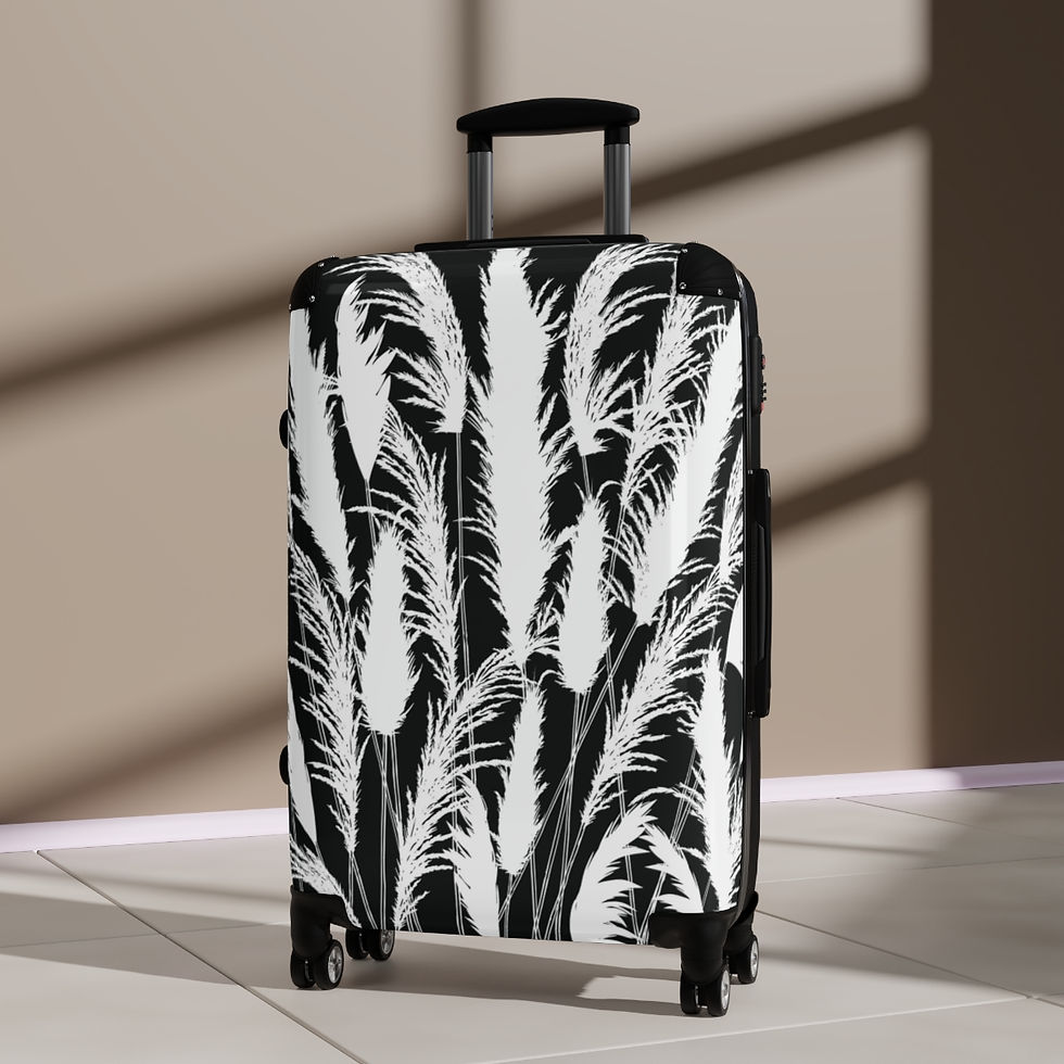 Black and white hard shell suitcase with printed white pampas grass silhouettes on a moonlit black background.