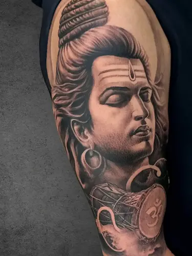 Realism style Shiva tattoo with Damru