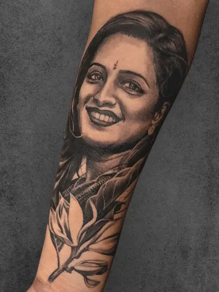 black and grey portrait on forearm