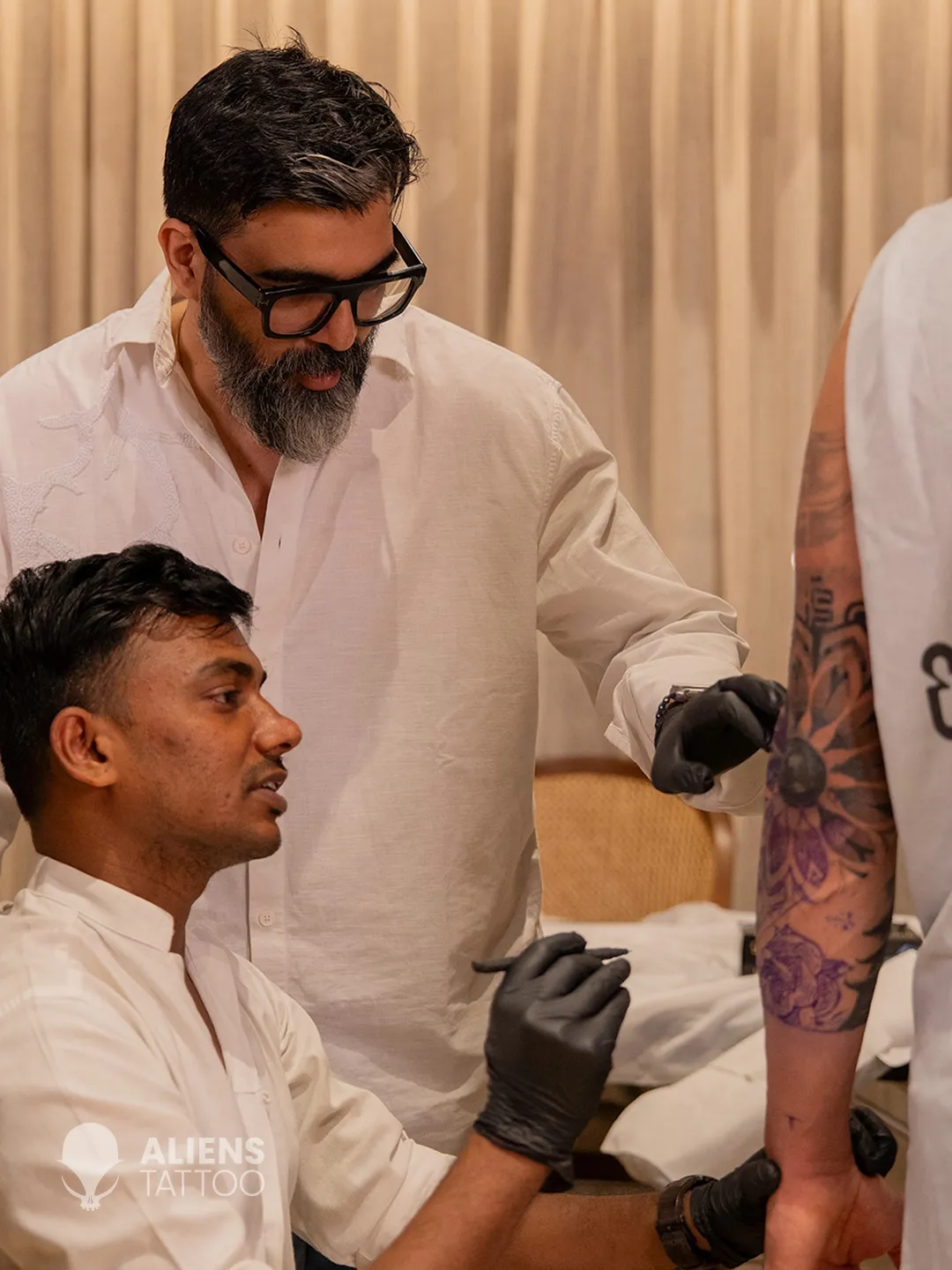 Devendra Palav tattooing Virat Kohli new tattoo sleeve during a session at Aliens Tattoo