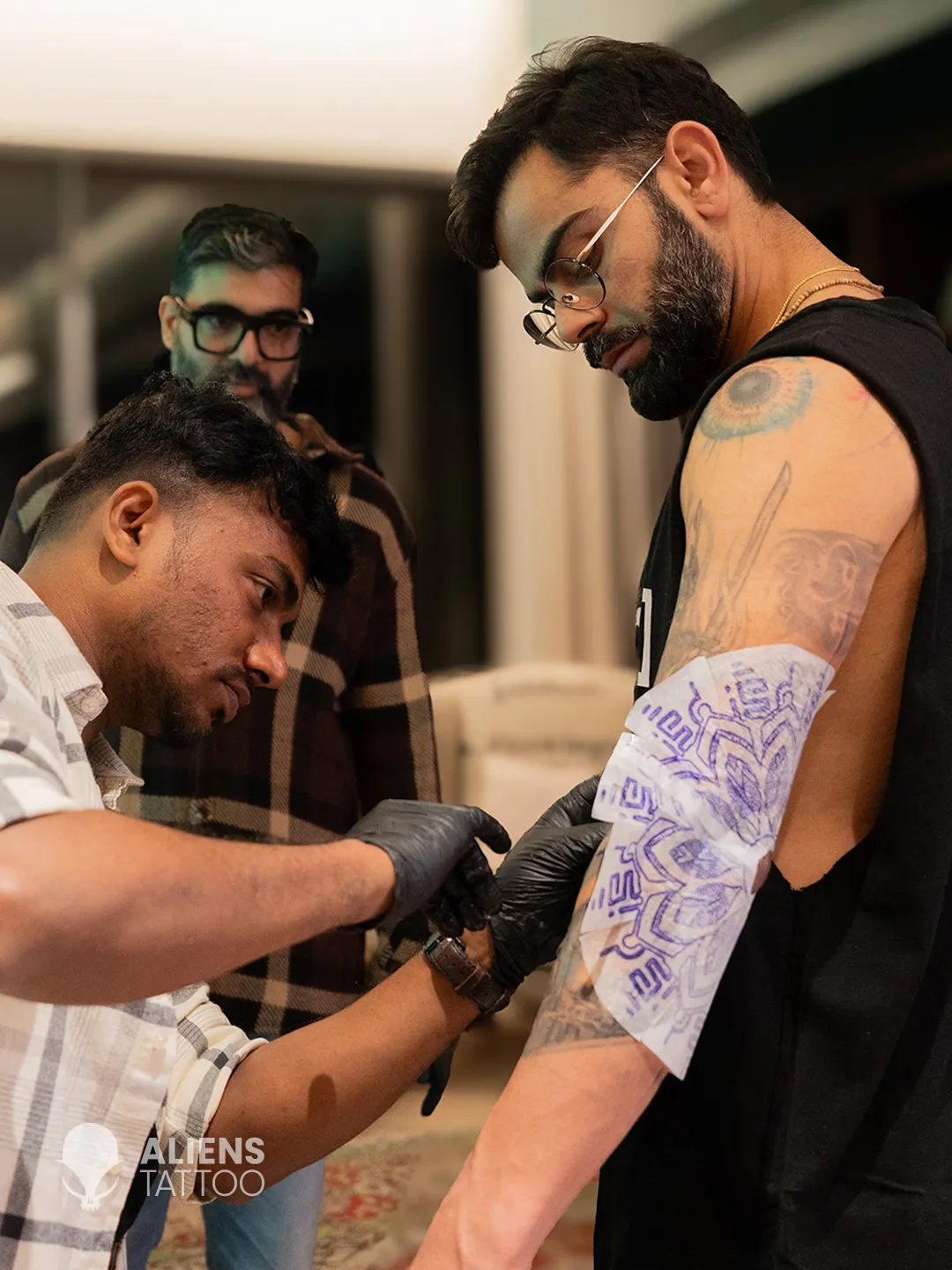 Devendra Palav tattooing Virat Kohli new tattoo during sleeve tattoo session at Aliens Tattoo
