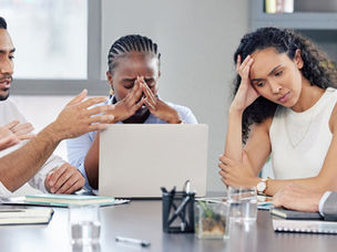 businesspeople looking stressed out while working together in an office