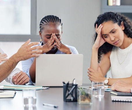 businesspeople looking stressed out while working together in an office