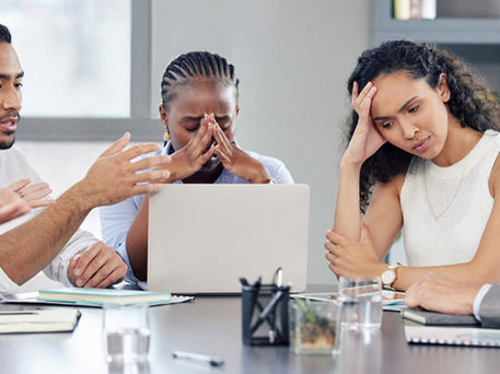 businesspeople looking stressed out while working together in an office