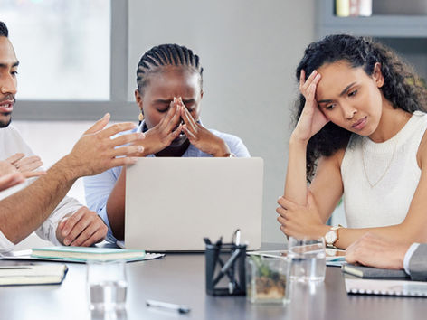businesspeople looking stressed out while working together in an office