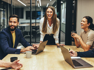 Happy businesspeople laughing during a meeting