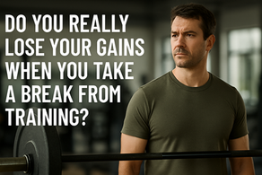 Person returning to the gym after a break, standing by a barbell, looking determined to rebuild strength.