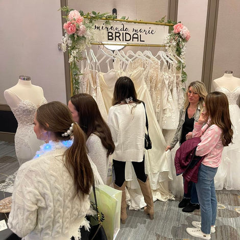 brides browsing wedding gowns at wedding expo