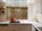 Classic white shaker kitchen with white marble engineered stone benchtop and dark grey integrated sink