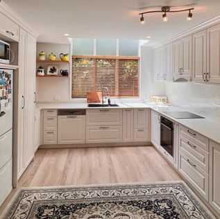 A transitional style kitchen with shaker style cabinets with pale ruddy cream tones