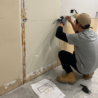 A carpenter installing a kitchen sheet
