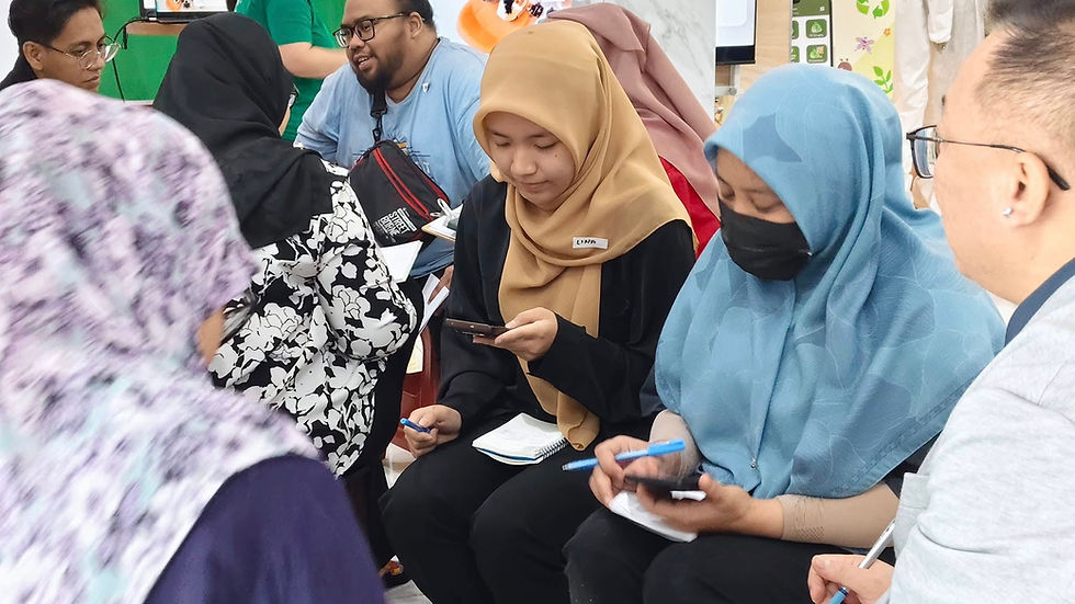 Employees participating in an interactive sustainability discussion and note-taking session during a Terra Green engagement activity.