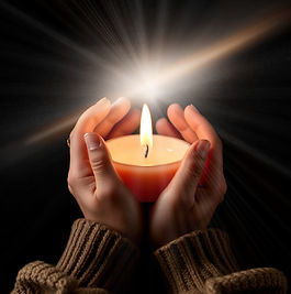 dark background with brown hands cradling a lited round candle.jpg
