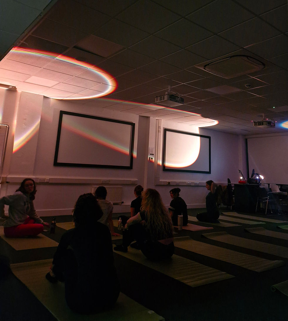 Atmospheric yoga room with warm circular lighting.