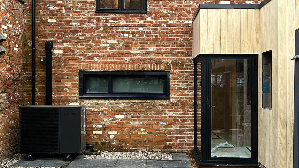 Air source heat pump unit mounted on external cladding
