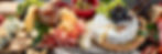 Fruit and Cheese Board with several semi hard and soft cheeses from around the world