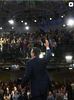 Stephen Colbert from behind waving at his audience