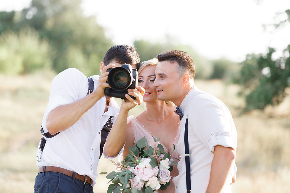 Couple looking at the photo their photographer is showing them after taking their pictures