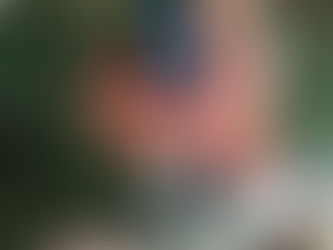 Michelle, sitting on a bench holding her yoga mat