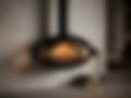 Firefly_Gemini Flash_suspended black fireplace with softly glowing fire inside, warm orang