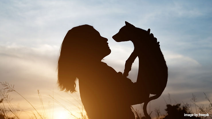Woman carry her pet and hugging up to the sky.