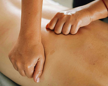 Two hands performing a foot reflexology massage on a client at Zenvida wellness center in Madrid
