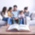 A family sitting together on a couch, supporting each other with gentle body language. Sof