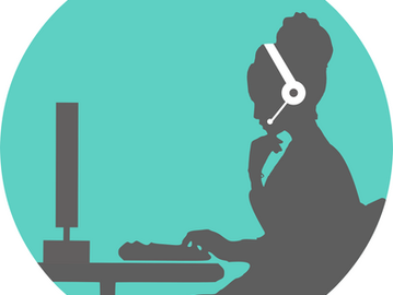 Silhouette of virtual assistant wearing a headset, sat her computer at a desk, typing.