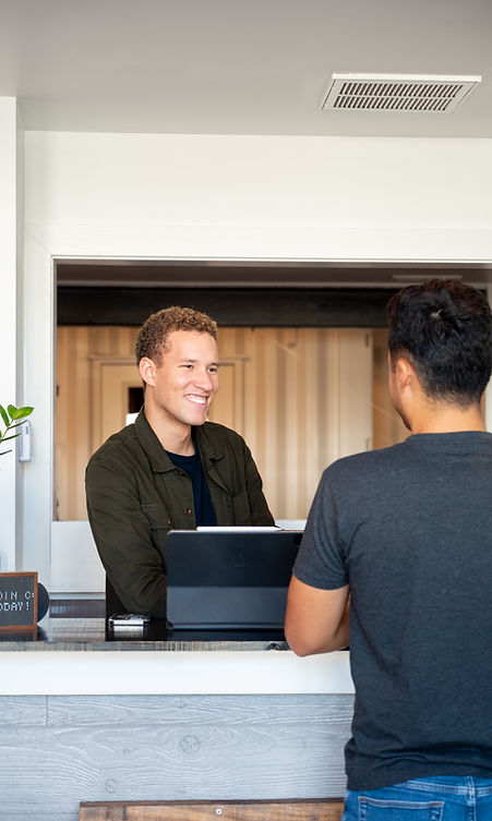 Person being greeted at the front desk of CoWorx