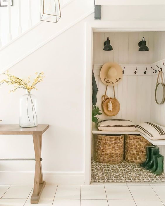 under stairs coat storage with baskets and seating