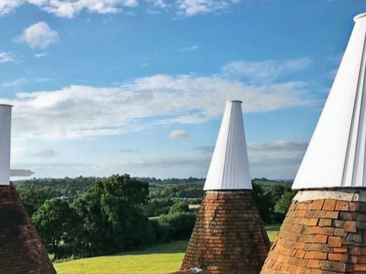 3 traditional Kent oast house with white wooden cowls in Kent