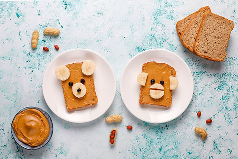 funny-bear-monkey-face-sandwich-with-peanut-butter-banana-black-currant-top-view.jpg