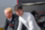 Image of Bryce Aron and his engineer Paul moving the car to the grid