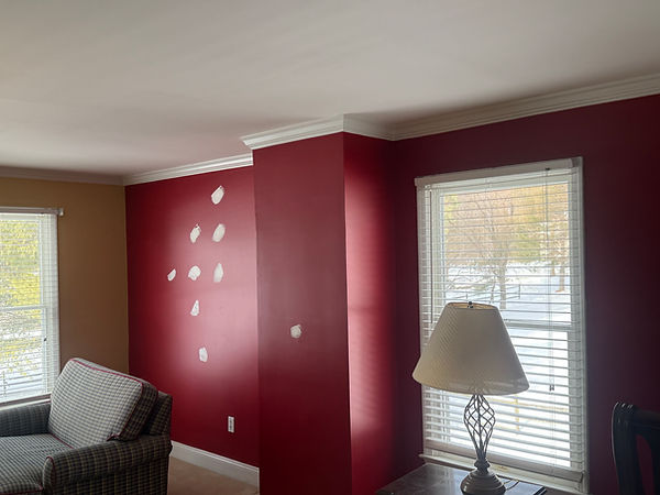 Residential hallway leading to a freshly painted bedroom