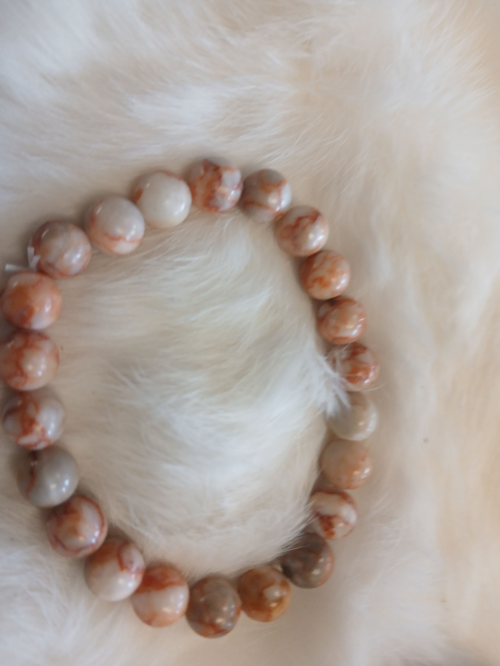 White/gray beads with red-orange veining