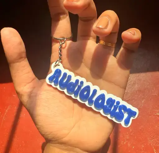Thumbnail: Hand holding Audiologist keychain