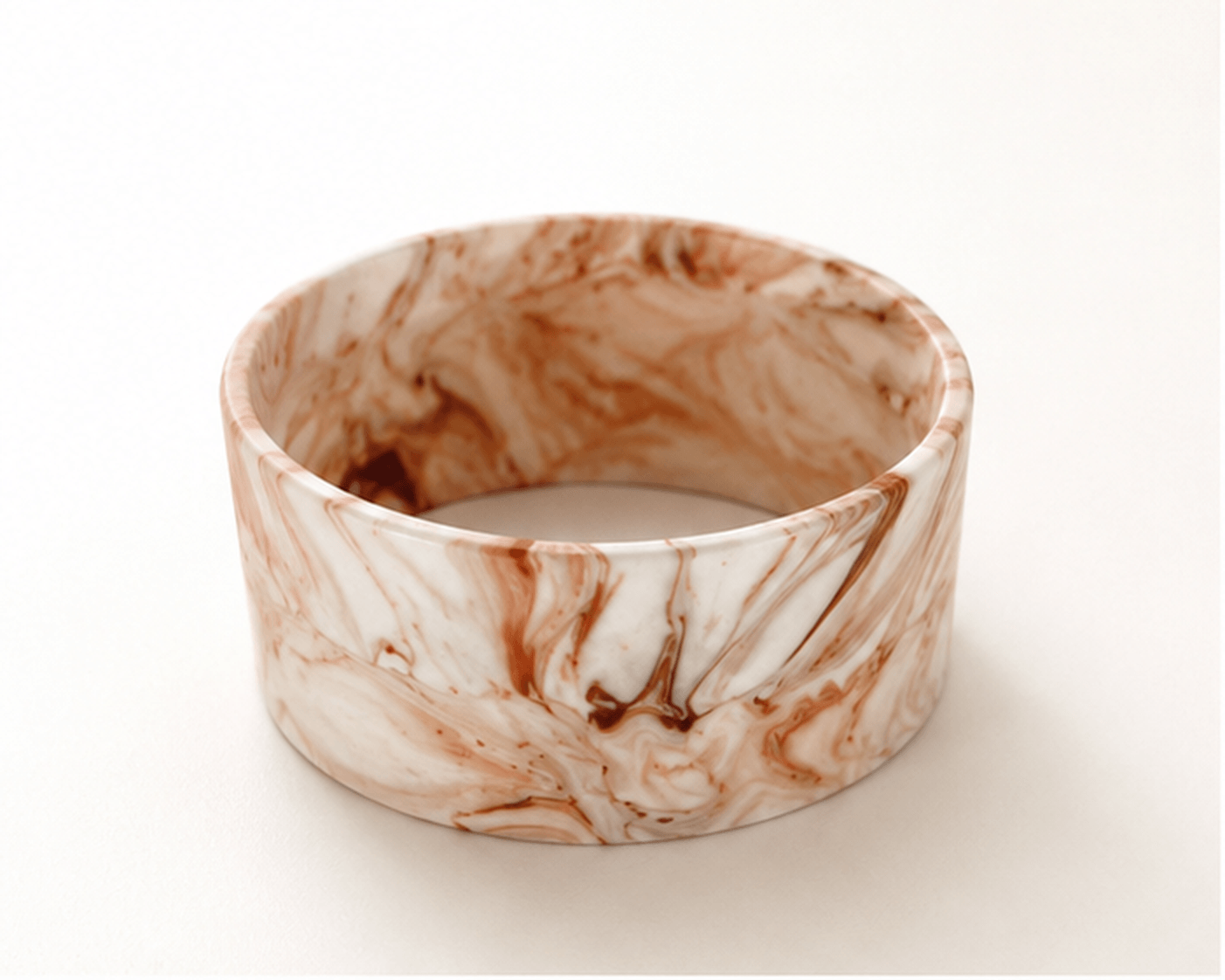 Handcrafted sculptural statement bangle in Umber Vein marbled mineral composite by Australian jewellery brand Guseli Design