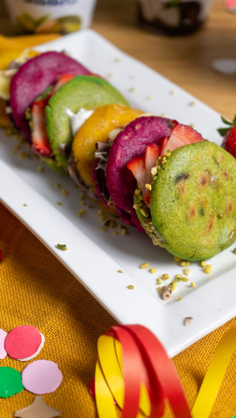 Arepas colorate con ripieno dolce, verdi, rosse e gialle in contesto Carnevale