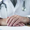 crop-doctor-holding-hands-desk.jpg