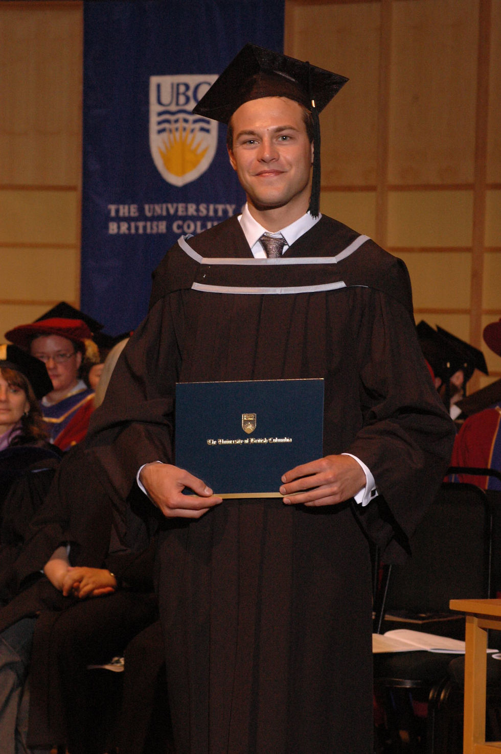 Me standing with my Bachelors Degree