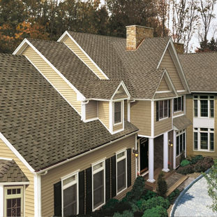 Weathered Wood Roof on a off beige siding house