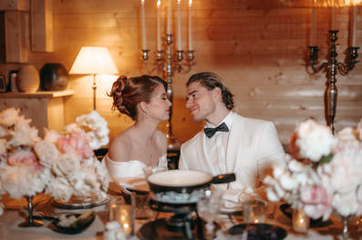couple about to kiss by the table set for a fondue