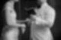 Bride and groom holding hands, close up, showing engagement ring. Groom is reading vows in a white suit, bride is wearing a white dress by Viviane Westwood, in Zurich, at the registry office (standesamt).