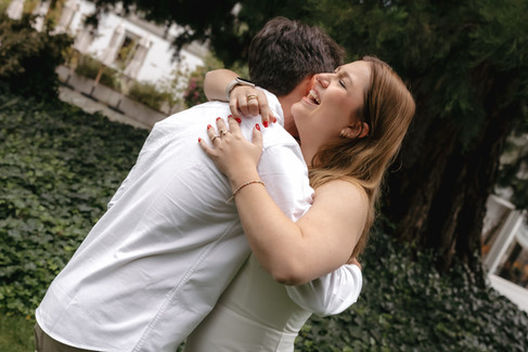 A luxury marriage proposal in Zurich, Switzerland at 5 stars hotel Baur au Lac with Tiffany's diamond ring: couple holding each other closed while laughing visibly emotional